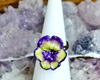 Yellow pansy ring hemmed with purple in cold porcelain, tricolor violet flower from gardens and nature