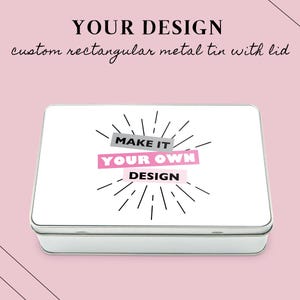 May include: A rectangular metal tin with a lid, displaying the text "MAKE IT YOUR OWN DESIGN" in pink and black. The tin has a white surface and silver edges, set against a pink background with black diagonal lines. The text "YOUR DESIGN" is at the top.
