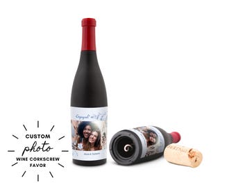May include: A black wine bottle with a red top and a custom photo label that says "Engaged!". A second bottle lies on its side, and a cork is next to it. The image also includes the text "CUSTOM photo WINE CORKSCREW FAVOR".