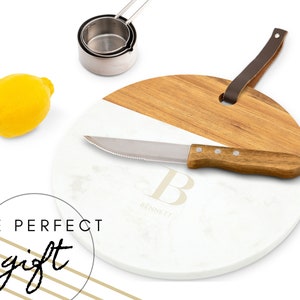 May include: A round white and brown cutting board with a knife and the letter "B" with the name "Bennett" underneath.