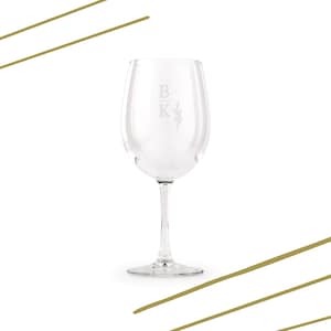 May include: A clear wine glass with a long stem, featuring etched initials "B K" and a floral sprig design. The glass is set against a white background with gold diagonal lines, suitable for serving wine.