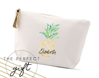 May include: White canvas zippered pouch with a gold tassel. The pouch features a watercolor-style illustration of a pineapple with the name "Elizabeth" written underneath.