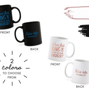 May include: Two black and white coffee mugs with different text on each side. The black mug has the text "Does this RING make me look ENGAGED?" on the front and "Future Mrs. MORRISON" on the back. The white mug has the text "Does this RING make me look ENGAGED?" on the front and "Future Mrs. MORRISON" on the back. The text on the black mug is in blue, and the text on the white mug is in rose gold.