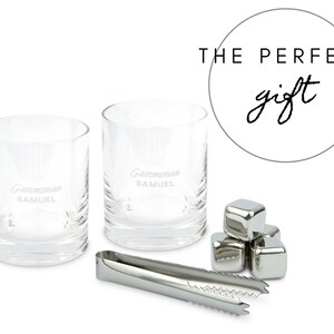 May include: Two clear glass tumblers with the text "Groomsmom Samuel" etched on the front. The glasses are next to a set of stainless steel ice cubes and a pair of tongs. The text "THE PERFECT gift" is written in a circle above the glasses.