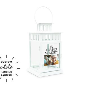 May include: White custom photo hanging lantern with a handle. The lantern features a photo of a woman and a dog, with the text "IN LOVING MEMORY". The lantern is a memorial item.