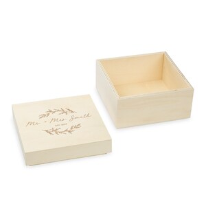 May include: A wooden box with a lid, engraved with the text "Mr. + Mrs. Smith Est. 2019" and a floral design.