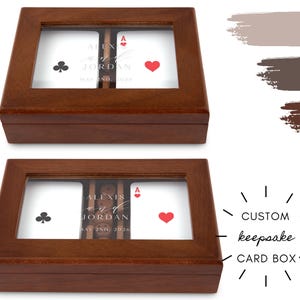 May include: Two wooden card boxes with glass tops. Each box contains playing cards with a club and heart symbol, and personalized text. The boxes are labeled "ALEXIS & JORDAN MAY 2ND, 2026". The text "CUSTOM keepsake CARD BOX" is also visible.