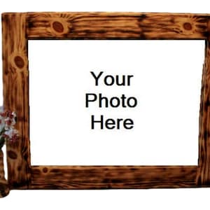 May include: A rustic wooden picture frame with a burnt finish. The frame has a white background with the text "Your Photo Here". A small vase with white flowers is attached to the left side of the frame.