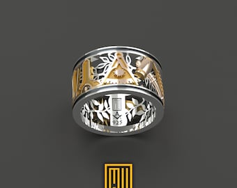 May include: A silver ring with a gold Masonic symbol and a design of leaves and branches. The ring is engraved with the number 925.