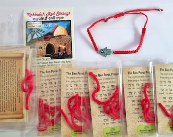 May include: A red string bracelet featuring a silver-toned hamsa charm with a blue eye detail, accompanied by several prayer cards in plastic sleeves. The cards include text titled Kabbalah Red Strings against evil eye and The Ben Porat Prayer.