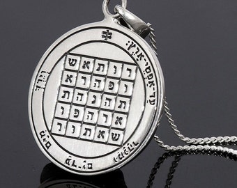 May include: Silver pendant necklace with a circular charm featuring a Hebrew inscription and a square grid of Hebrew letters. The pendant is attached to a silver chain.