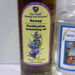 May include: A glass bottle of Ein Gedi Hyssop Purification Anointing Oil, a yellow label with a menorah and the text "Blessing from Jerusalem" in Hebrew and English. The bottle contains 100 ml or 3.4 fl. oz. of oil and is made in Israel.