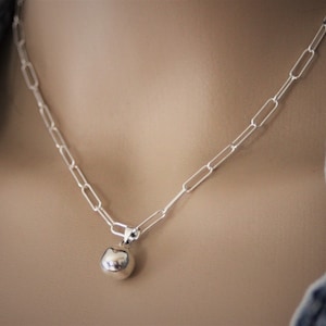 Sterling silver necklace with large rectangle chain links in trombone style with ball pendant
