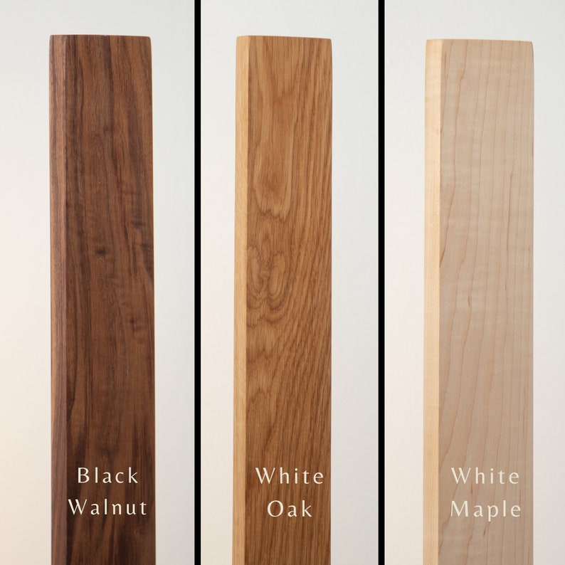 May include: Three wooden planks in a vertical arrangement, each with a different wood type. From left to right, the planks are black walnut, white oak, and white maple. Each plank has the wood type labeled in white text.