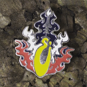 May include: A yellow, red, white, and blue enamel pin with a stylized flame design and a letter "O" in the center.