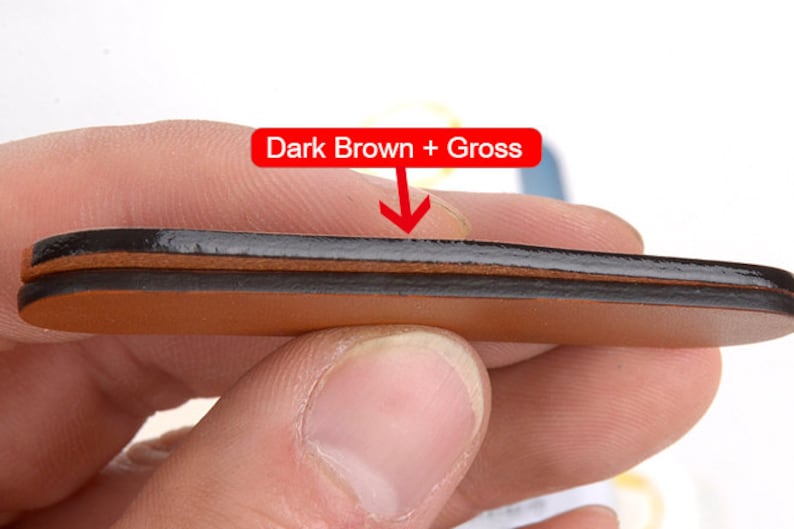 May include: Close-up of a layered leather product with a dark brown top layer and a lighter brown base. The text "Dark Brown + Gross" is displayed in a red box above the product.