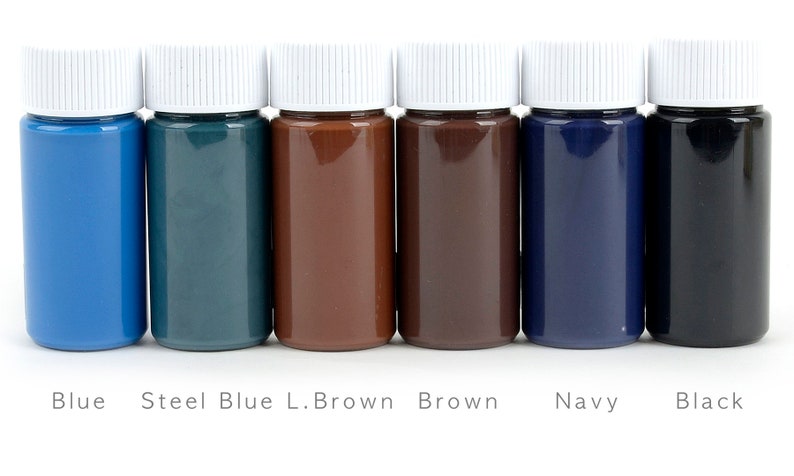 May include: Six small bottles of paint in a row, each with a white cap. The colors are blue, steel blue, light brown, brown, navy, and black. The names of the colors are printed below each bottle.