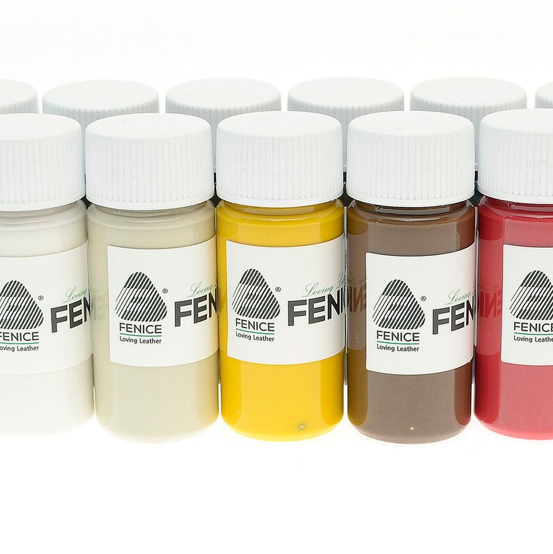 May include: A collection of small paint bottles with white lids. The bottles contain various colors, including white, beige, yellow, brown, and red. Each bottle has a label with the text "FENICE Loving Leather".