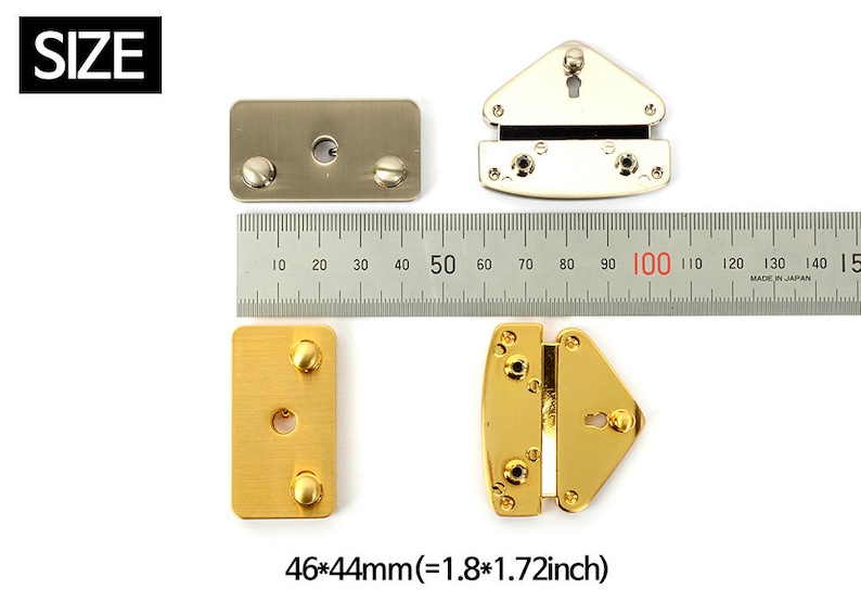 May include: Various metal hardware pieces, including rectangular and triangular shapes, are displayed with a ruler for size comparison. The pieces are gold and silver-toned, with screw and keyhole details. The dimensions are 1.8 x 1.72 inches.