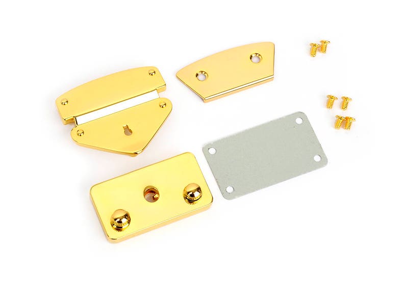 May include: A set of gold-colored metal purse hardware components, including a clasp, two curved pieces, a rectangular plate, and small screws. The hardware is new and shiny, ideal for crafting or repair projects.