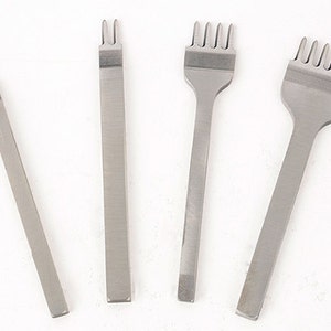 May include: Four silver-colored leather working tools are arranged on a white background. The tools include a single-prong tool, a two-prong tool, a four-prong tool, and a five-prong tool. These tools are used for stitching leather.