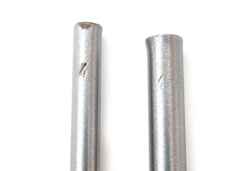 May include: Two silver metal rods, each marked with the number '4'. The rods are cylindrical and have a slightly textured surface. The background is plain white.