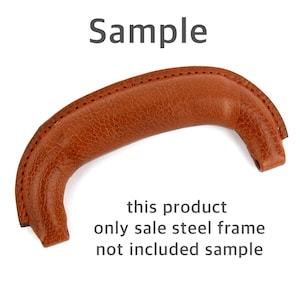 May include: A brown leather handle with a curved design. The handle has a stitched seam along the top and text that reads "Sample" and "this product only sale steel frame not included sample".