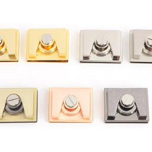 May include: Seven square metal clasps in gold, silver, and rose gold finishes. Each clasp has a central, circular screw head and a rectangular base. The clasps are displayed against a white background.