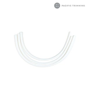 May include: Three white elastic bands, each with a slight curve, are arranged in a semi-circle shape.