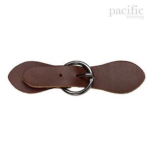 May include: A brown leather strap buckle with a silver metal ring. The strap is designed to be used as a closure for a garment or accessory.