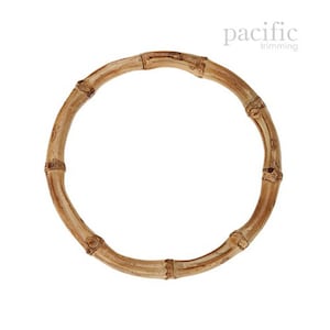 May include: A natural brown bamboo ring handle for a bag or tote. The handle is made of woven bamboo and is approximately 10 inches in diameter.