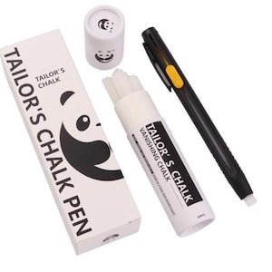 May include: A tailor's chalk pen set featuring a black plastic pen with a yellow button, a white cylindrical container holding white chalk refills, and a rectangular white box. The packaging displays panda graphics and the text TAILOR'S CHALK PEN.