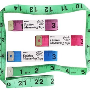 May include: Three 60-inch fashion measuring tapes. One is pink, one is blue, and one is green. Each tape has the words "Allary. Fashion Measuring Tape" printed on it.
