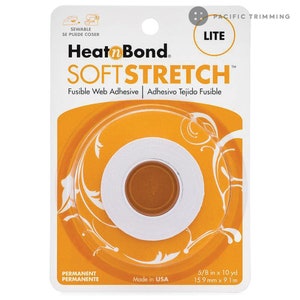 May include: A roll of white Heat n Bond Soft Stretch Lite fusible web adhesive on a yellow and white background. The label says "Sewable, Se Puede Coser, Heat n Bond, Soft Stretch, Fusible Web Adhesive, Adhesivo Tejido Fusible, Permanent, Permanente, Made in USA, 5/8 in x 10 yd, 15.9 mm x 9.1 m".