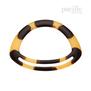 May include: A tortoiseshell hair clip with a curved shape and a single opening in the center.