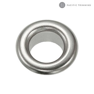 May include: Silver metal grommet with a smooth, shiny finish. The grommet has a circular shape with a hole in the center.