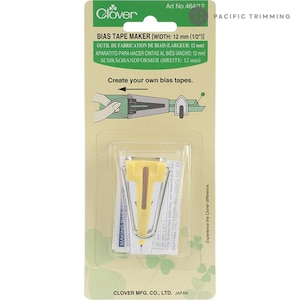 May include: A yellow bias tape maker tool for creating bias tape, 1/2 inch wide. The tool is packaged on a card with the Clover logo and the text "Create your own bias tapes."
