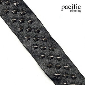 May include: Black leather trim with silver pyramid studs. The trim is approximately 1 inch wide.