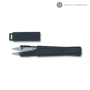 May include: A small, black, plastic, retractable thread snips with a silver blade. The snips are closed and have a black plastic case.