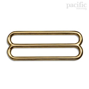 May include: Gold metal slider buckle with two loops.