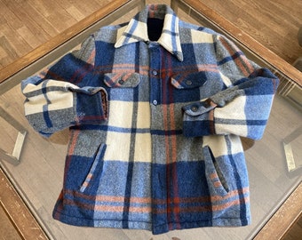 May include: A blue, orange, and cream plaid jacket with a button-up front, two chest pockets, and two side pockets. The jacket has a collar and buttoned cuffs. The fabric appears to be a thick, warm material.