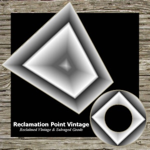 May include: Black and white graphic design with two geometric shapes. The larger shape is a white diamond with a smaller white diamond inside. The smaller shape is a white square with a black circle inside. The text "Reclamation Point Vintage" and "Reclaimed Vintage & Salvaged Goods" is below the shapes.