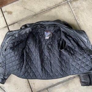 May include: Black leather jacket with a quilted lining and a small patch with an eagle design on the inside.