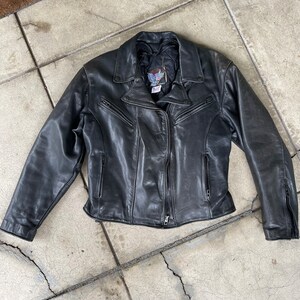 May include: A black leather motorcycle jacket with a zipper closure and multiple pockets.
