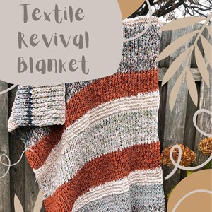 May include: A striped knitted blanket with orange, white, and gray stripes. The blanket is made with a chunky yarn and has a textured look. The blanket is hanging on a wooden fence with leaves and branches in the background. The text "Textile Revival Blanket" is written in a large font on a beige background.