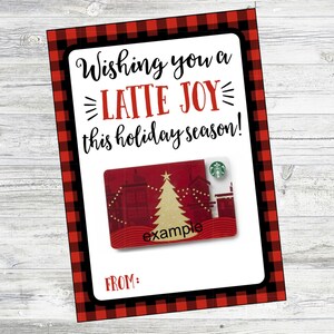 May include: A red and black plaid gift card holder with the text "Wishing you a LATTE JOY this holiday season!" and a Starbucks gift card with a Christmas tree design. The gift card has the text "example" on it.