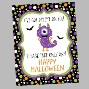 May include: Purple monster with one eye and a toothy grin on a white background with the text "I've got my eye on you. Please take only one! Happy Halloween."  The background is a black and white polka dot pattern with orange and green polka dots.