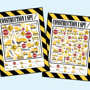 May include: Two black and yellow striped cards with the text "CONSTRUCTION I SPY" on them. Each card has a grid of construction-themed images, including trucks, cones, stop signs, saws, and shovels. The cards have blank lines below the grid for writing.