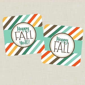 May include: Two square gift tags with a striped pattern in brown, orange, yellow, green, and blue. The tags have a circle with the text "Happy Fall Y'all!" in brown text.