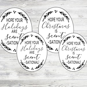 May include: Four round white gift tags with black calligraphy. The tags feature a wreath design with the text "Hope your Holidays are Scent-sational!" and "Hope your Christmas is Scent-sational!"